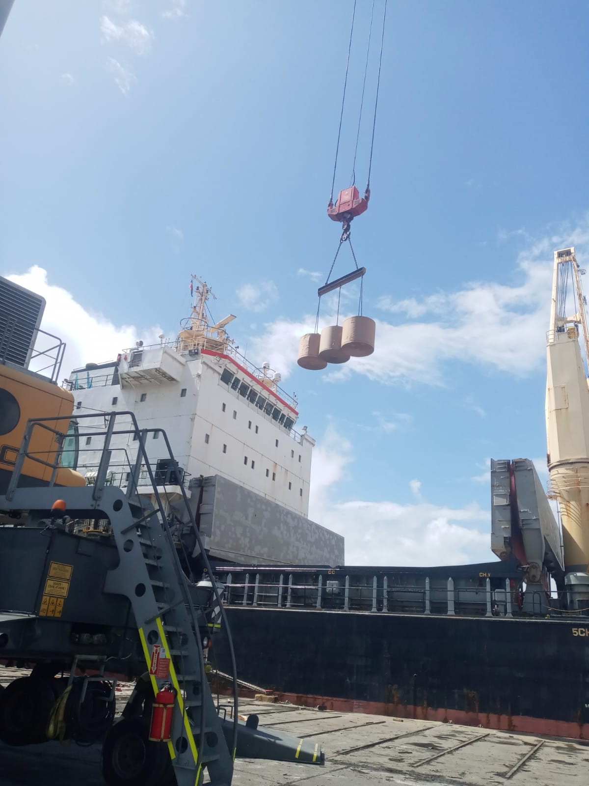 Cargo rolls being lifted beside a vessel